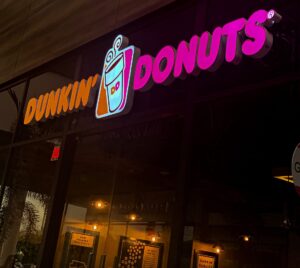 Illuminated channel letter sign displaying the Dunkin’ Donuts logo on a storefront